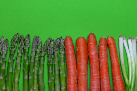 Fresh vegetables creative green background. Vegan Food Concept with raw organic vegetables. Carrot,...