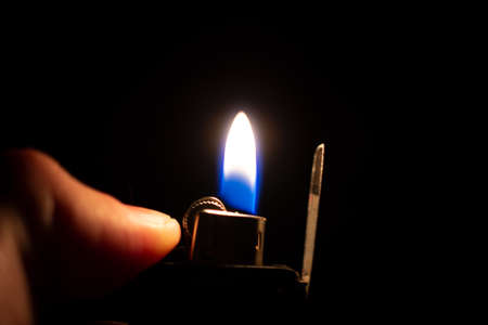 ignited ligther with black backgroundの写真素材