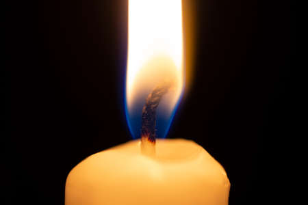 closeup of a small burning candleの写真素材