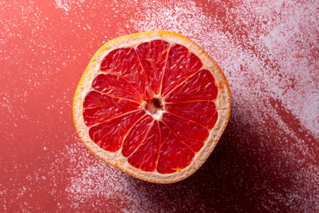 Grapefruit on a red background, top view, copy spaceの写真素材