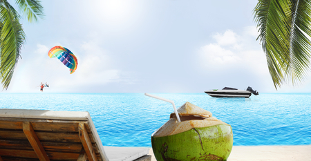beach chair with coconut with summer beach background. Paragliding and speedboatの写真素材