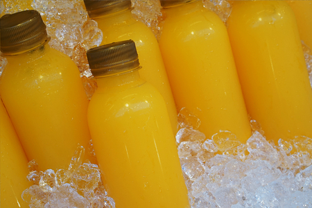 passion fruit juicy juice bottles with cold ice in half litre palstic bottlesの写真素材
