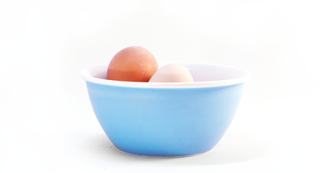 brown and white egg in blue bowl