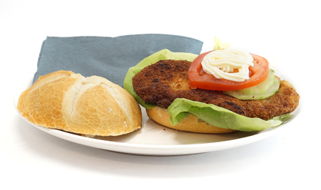 Wiener schnitzel in a bun with lettuce tomato and mayonnaise