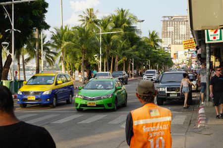 Pattaya beach road in october 2017 with motorbike taxi driver and cabs
