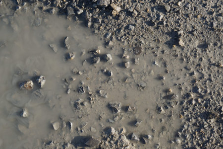 water puddle dirt road with small pebbles
