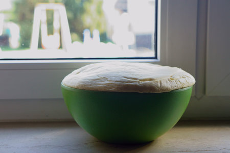 homemade yeast dough for yeast braid on windowsill