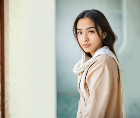 Portrait of young woman in neutral clothing with calm expression, soft fabrics long sleeveの素材