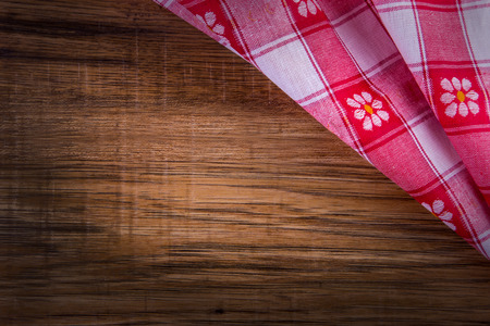 Top view of checkered napkin on empty wooden tableの写真素材
