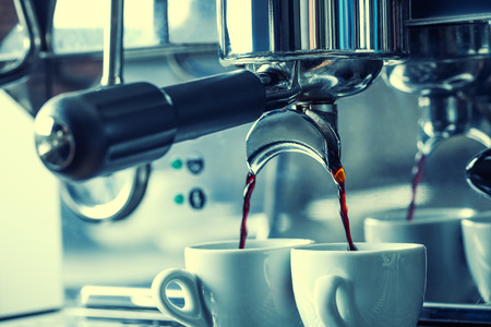 Preparation of two espresso in coffee machines.Professional coffee machine making espresso in a Two cafe.の写真素材