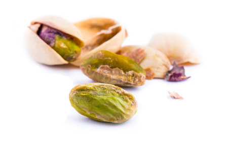 Roasted pistachios on a white background. Macroの写真素材