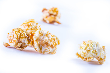 A pile of caramel popcorn on a white background. Macro conceptの写真素材