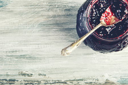 Close up of thick sweet strawberry jam with old spoon. Top view of fruity jam.の写真素材