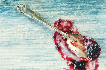 Close up of thick sweet strawberry jam with old spoon. Top view of fruity jam.の写真素材