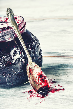 Close up of thick sweet strawberry jam with old spoon. Top view of fruity jam.の写真素材
