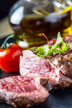 Grilled Beef steak with vegetable decoration. Grilled porterhouse steak on slate board.の写真素材