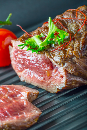 Grilled Beef steak with vegetable decoration. Grilled porterhouse steak on slate board.の写真素材