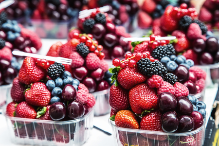 Berry fruits at a marketplace Blueberries, raspberries, strawberries, cherries Forest fruits. Gardening ,agriculture,harvest and forest concept.の写真素材