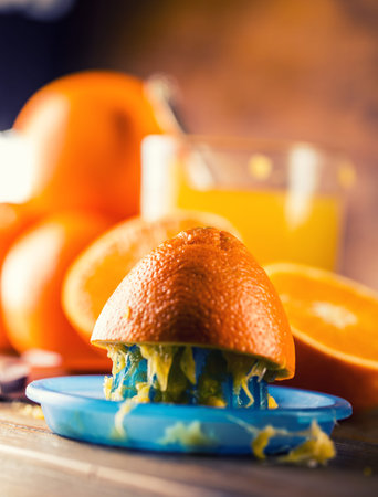 Fresh oranges. Cut oranges. Pressed orange manual method. Oranges and sliced oranges with juice and...