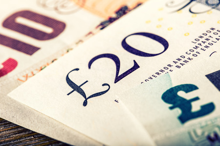 Pound currency, money, banknote.  English currency. UK banknotes of different values stacked on each...