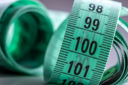 Curved measuring tape. Measuring tape of the tailor. Closeup view of Green measuring tape.の写真素材