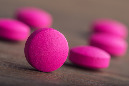 Pills. Tablets. Capsule. Heap of pills. Medical background. Close-up of pile of yellow green tablets...