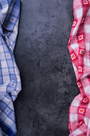 Top view of checkered kitchen tablecloth on granite -  concrete - stone background. Free space for your text or products.の写真素材