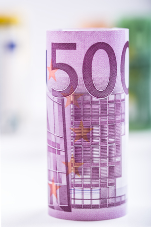 Several hundred euro banknotes stacked by value. Euro money concept. Rolls Euro  banknotes. Euro currency. Announced cancellation of five hundred euro banknotes. Banknotes stacked on each other in different positions. Toned photo.の写真素材