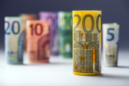 Several hundred euro banknotes stacked by value. Euro money concept. Rolls Euro  banknotes. Euro currency. Announced cancellation of five hundred euro banknotes. Banknotes stacked on each other in different positions. Toned photo.の写真素材