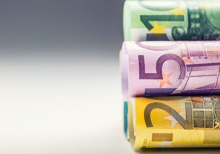 Several hundred euro banknotes stacked by value. Euro money concept. Rolls Euro  banknotes. Euro currency. Announced cancellation of five hundred euro banknotes. Banknotes stacked on each other in different positions. Toned photo.の写真素材