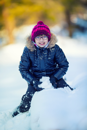 Portrait of a little girl in the snow. Winter joy of a child of a lot of snow.の写真素材