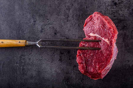 Steak. Raw beef steak. Fresh raw Sirloin beef steak sliced o Herb - Rosemary decoration.の写真素材