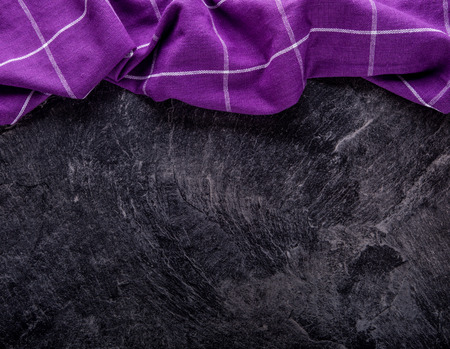 Top view of checkered kitchen purple tablecloth on concrete - stone - marble -  wooden background. Free space for your text or products.の写真素材