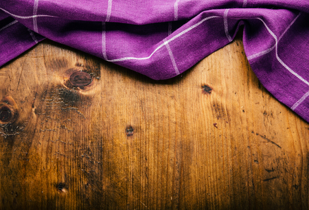 Top view of checkered kitchen purple tablecloth on concrete - stone - marble -  wooden background. Free space for your text or products.の写真素材