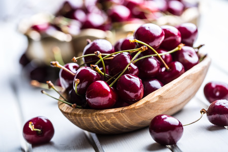 Cherries. Sweet Cherries. Fresh Cherries. Ripe cherries on wooden concrete table - board.の写真素材