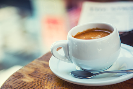 Coffee break business. Cup of coffee mobile phone and newspaper.の写真素材