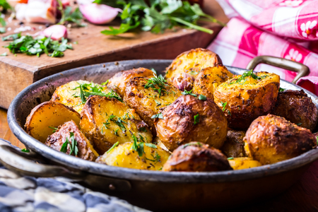 Potato. Roasted potatoes. American potatoes with smoked bacon garlic salt pepper cumin dill parsley - herb decoration.の写真素材