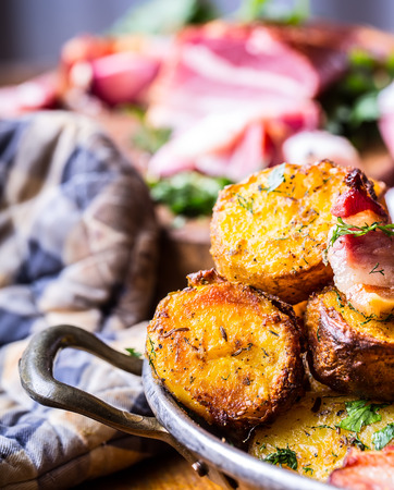 Potato. Roasted potatoes. American potatoes with smoked bacon garlic salt pepper cumin dill parsley - herb decoration.の写真素材