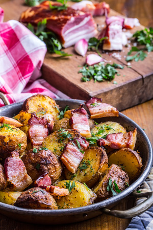 Potato. Roasted potatoes. American potatoes with smoked bacon garlic salt pepper cumin dill parsley - herb decoration.の写真素材