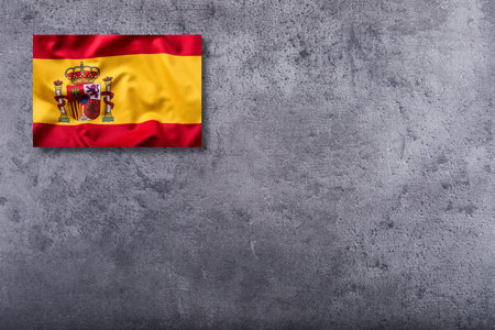 Waving flag of Spain on concrete background.の写真素材