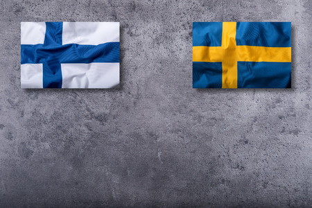 Flags of the finland and sweden on concrete background.の写真素材