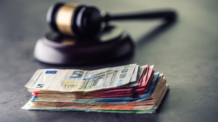 Judge's hammer gavel. Justice and euro money. Euro currency. Court gavel and rolled Euro banknotes. Representation of corruption and bribery in the judiciary.の写真素材