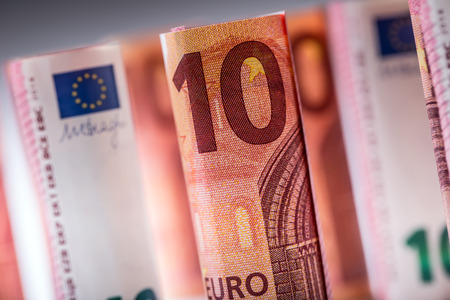Several hundred euro banknotes stacked by value.Rolls Euro banknotes.Euro currency money. Banknotes stacked on each other in different positionsの写真素材