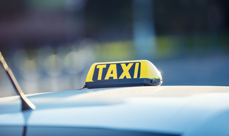 Taxi car waiting passengers in town.Taxi light on the cab of the car ready to transport the passengers.の写真素材