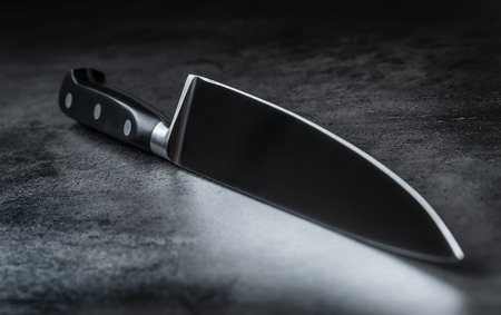 Knife. Kitchen knife lying on an modern concrete cutting board.の写真素材