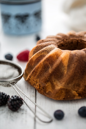 Cake. Marble cake cup of coffee powder sugar kitchen vintage utensil and fresh fruit berries.の写真素材