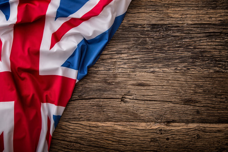 Flag of UK  on old wooden background. Union Jack  flag on old oak background.の写真素材