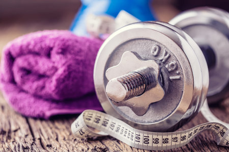 Fitness Equipment. Kettlebell  dumbbells towel water and measuring tape.の写真素材