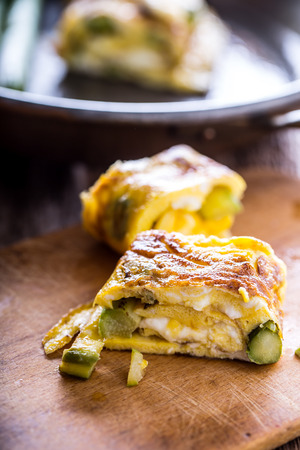 Asparagus and omelette.Omelette stuffed with asparagus  and cheese for a breakfast.の写真素材