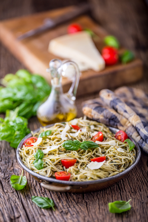 Spaghetti. Italian pasta spaghetti with basil pesto cherry tomatoes and olive oil.の写真素材